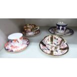 Four dissimilar Royal Crown Derby china tea cups and saucers,