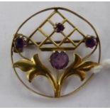 An 'antique' gold coloured metal framed, round brooch,