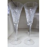 A pair of Waterford crystal wine flutes with incised decoration,