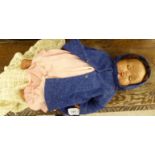 A 1950s composition doll with painted features,