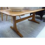 An Ercol light coloured elm coffee table, the top with round corners,