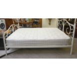 A modern white enamelled, tubular steel bed frame with faceted glass finials,