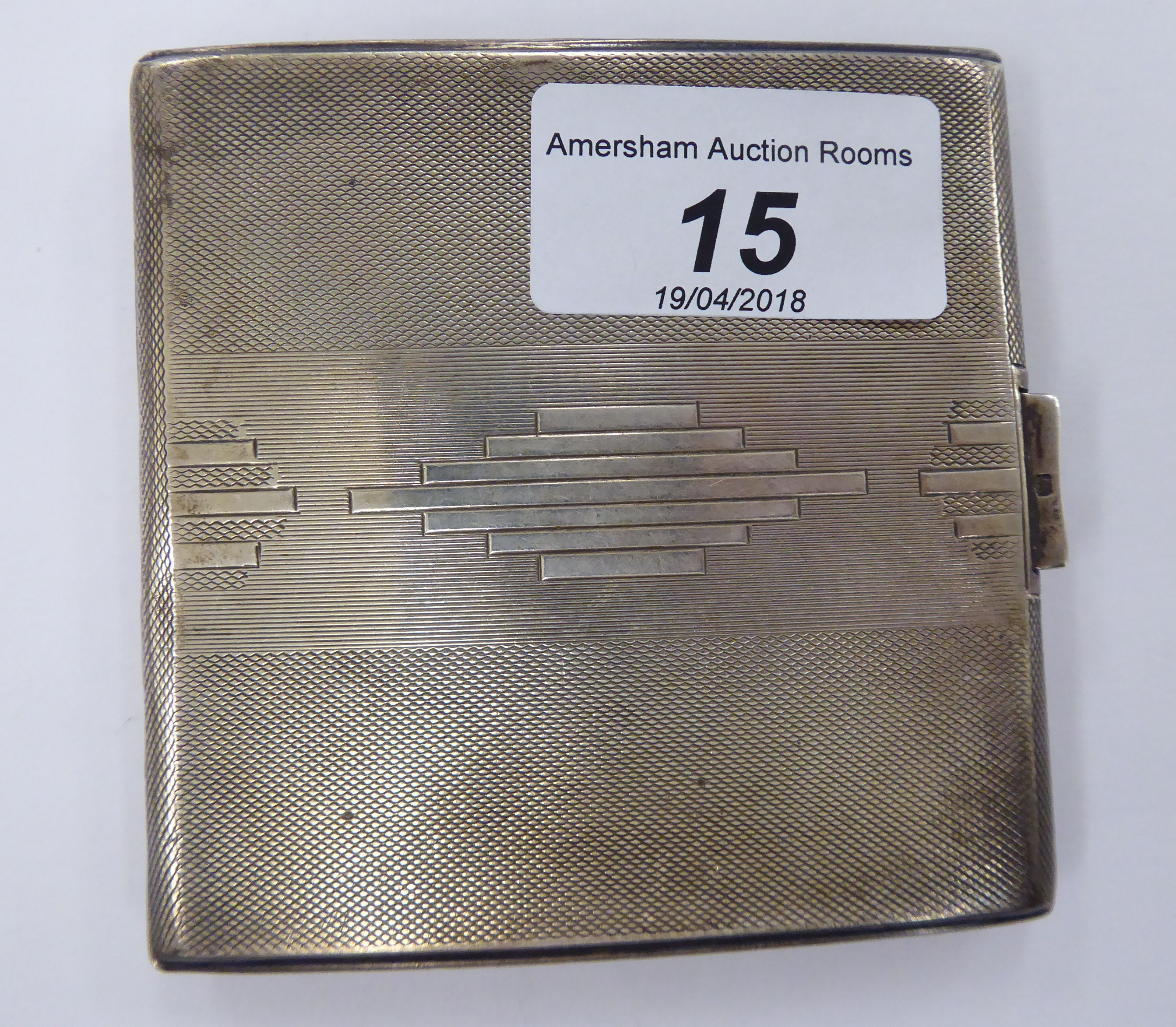 A silver folding cigarette case with Art Deco inspired decoration,