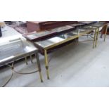 A pair and one modern brass framed coffee tables, each with a smoked plate glass tops,