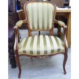 A Louis XV style, stained and carved showwood framed, open arm chair,