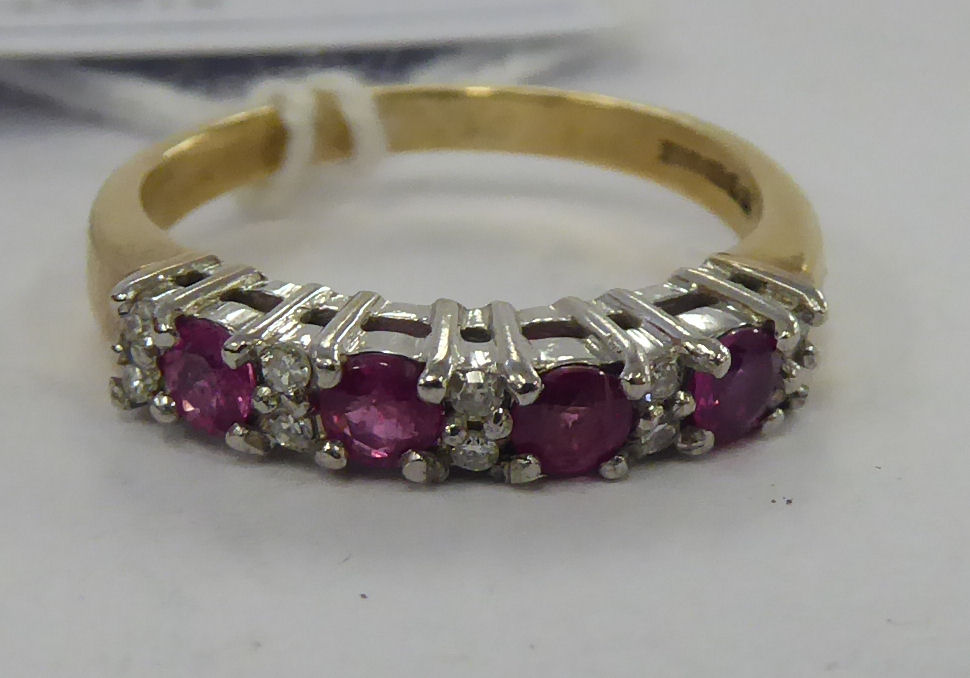 A 9ct gold claw set ruby and diamond half eternity ring 11
