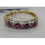 A 9ct gold claw set ruby and diamond half eternity ring 11