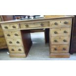 A late Victorian mahogany nine drawer, twin pedestal desk,