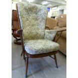 An Ercol beech framed high, spindled back arm chair,