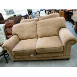A modern two person settee with a level back and scrolled arms,