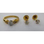 An 18ct gold single stone, claw set diamond ring; and a pair of gold coloured metal earrings,