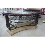 A modern oval, burnished hide finished coffee table with a bevelled,