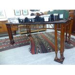 A modern mahogany and black painted dining table,