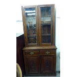 A late Victorian walnut cabinet bookcase, the upper part enclosed by a pair of panelled doors,