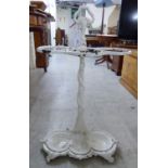 A Victorian style white painted cast alloy stickstand with a detachable drip tray base 27''h