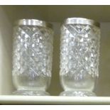 A pair of Edwardian glass vases with deep set diamond,