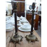 A pair of mid 20thC 'antique' effect gilt metal candlesticks with a tapered column and stepped