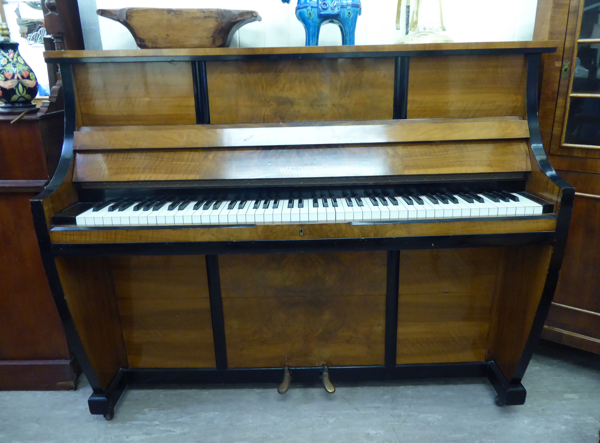 An Art Deco Waldberg, walnut veneered and ebonised, upright, iron framed piano 45.