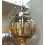 A mid 20thC brass pendant lamp with blown,