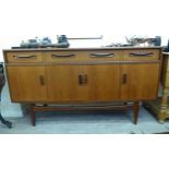 A G-plan teak sideboard with three in-line drawers, over four doors,