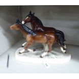 A Continental china model, two galloping horses,
