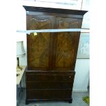 A late Victorian Georgian design walnut linen press with a dentil moulded cornice,