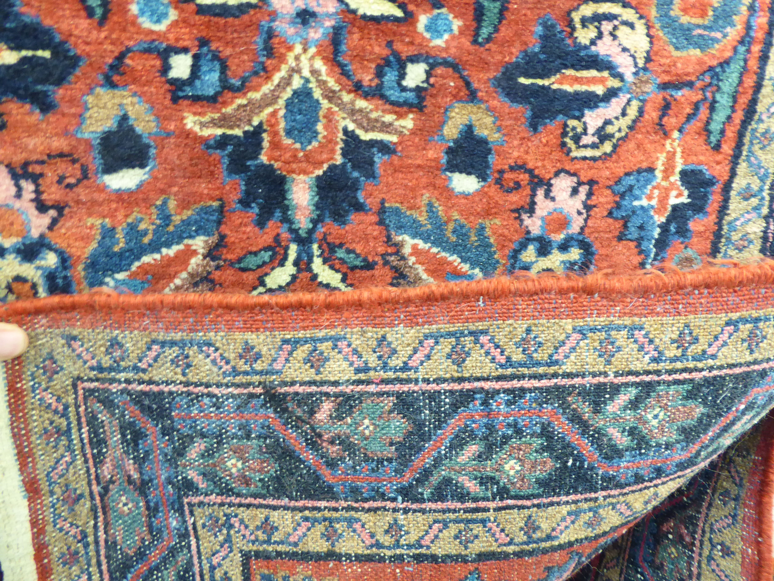 A Persian rug decorated with stylised flora on a red ground 31'' x 59'' SL - Image 3 of 3