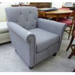 A modern armchair, part button upholstered in grey fabric, raised on square,