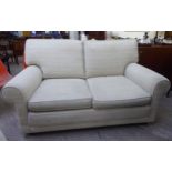 A modern two seater settee, upholstered in textured two tone cream coloured fabric,