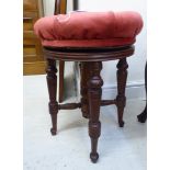 A late Victorian mahogany framed music stool, the pink dralon upholstered,