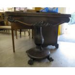 An early Victorian rosewood card table, the rotating foldover top enclosing a baise lined interior,