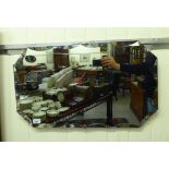 A 1930s mirror, the shaped, bevelled plate with canted corners,