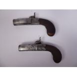 A pair of 19thC percussion muff pistols with finely engraved foliate scrolled decoration and