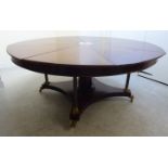 A mid 20thC Jupe inspired mahogany expanding dining table,