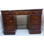 A late 19thC walnut desk, the top having a tooled red hide scriber and a moulded edge,
