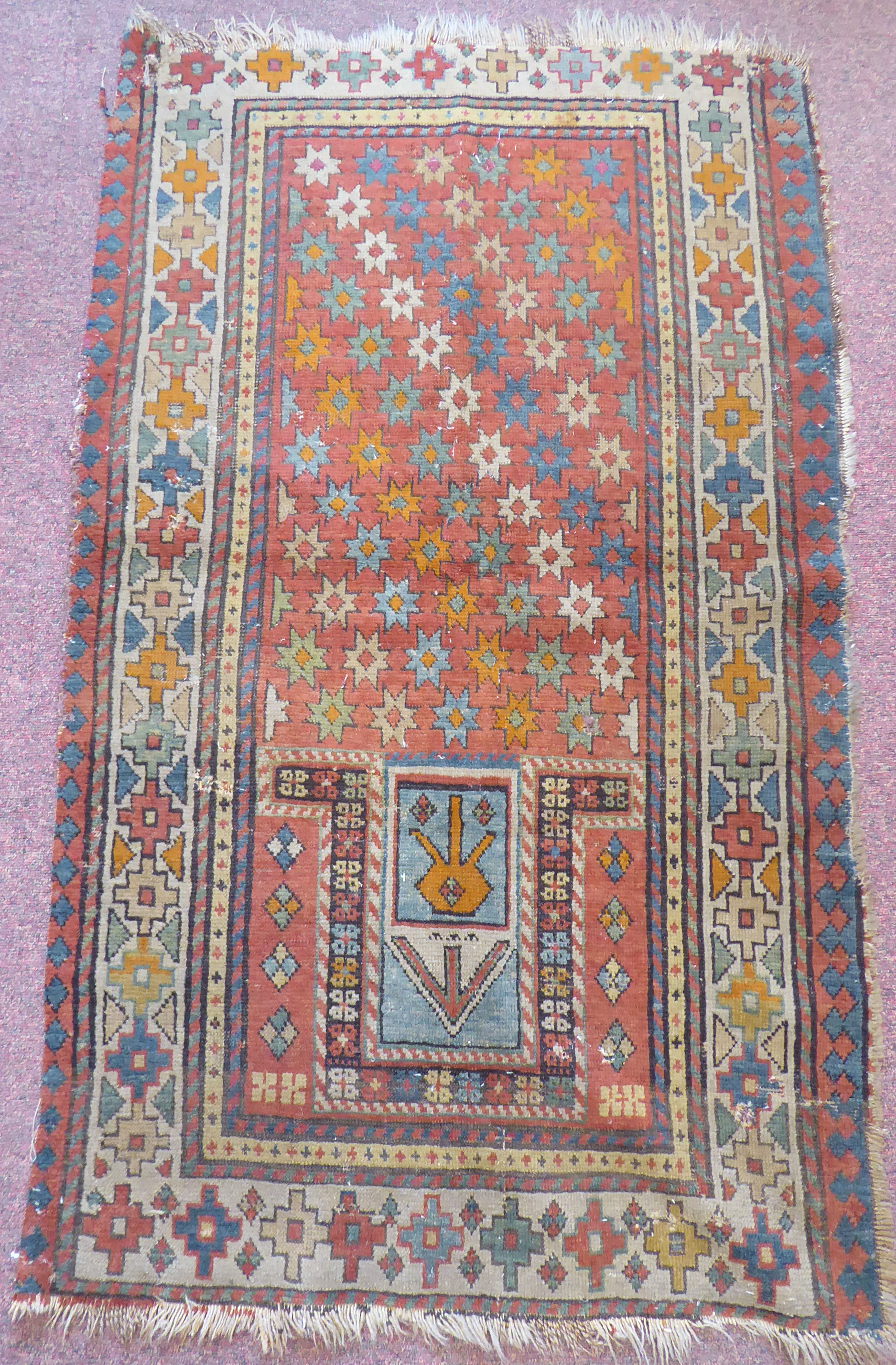 A 19thC Turkish prayer rug, decorated with stars,