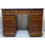 A late Victorian walnut desk, having a tooled, green hide scriber and thumb moulded edge,