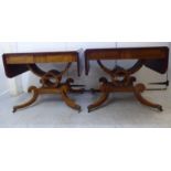 A pair of Regency revival rosewood sofa tables, each top with round corners, over two concealed,