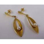 A pair of gold coloured metal leaf design pendant earrings,