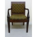 A late 19thC Colonial carved rosewood framed armchair with a level back and swept, open arms,