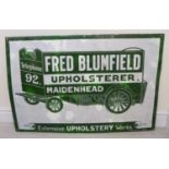 An enamelled steel, bottle green on white advertising sign 'Fred Blumfield, Upholsterer,