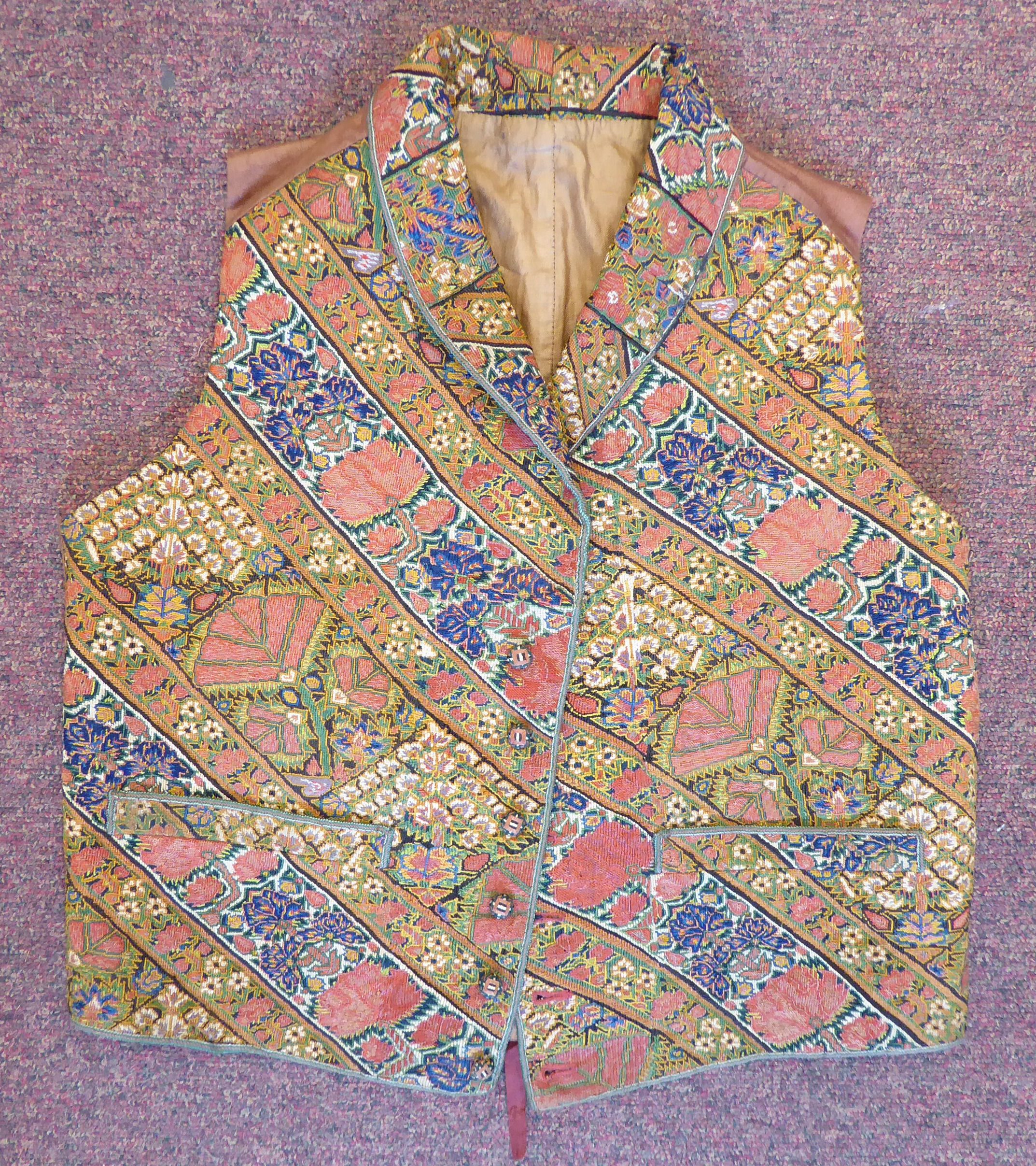 A mid 19thC silk lined gilet/waistcoat with a rolled collar and finely embroidered,