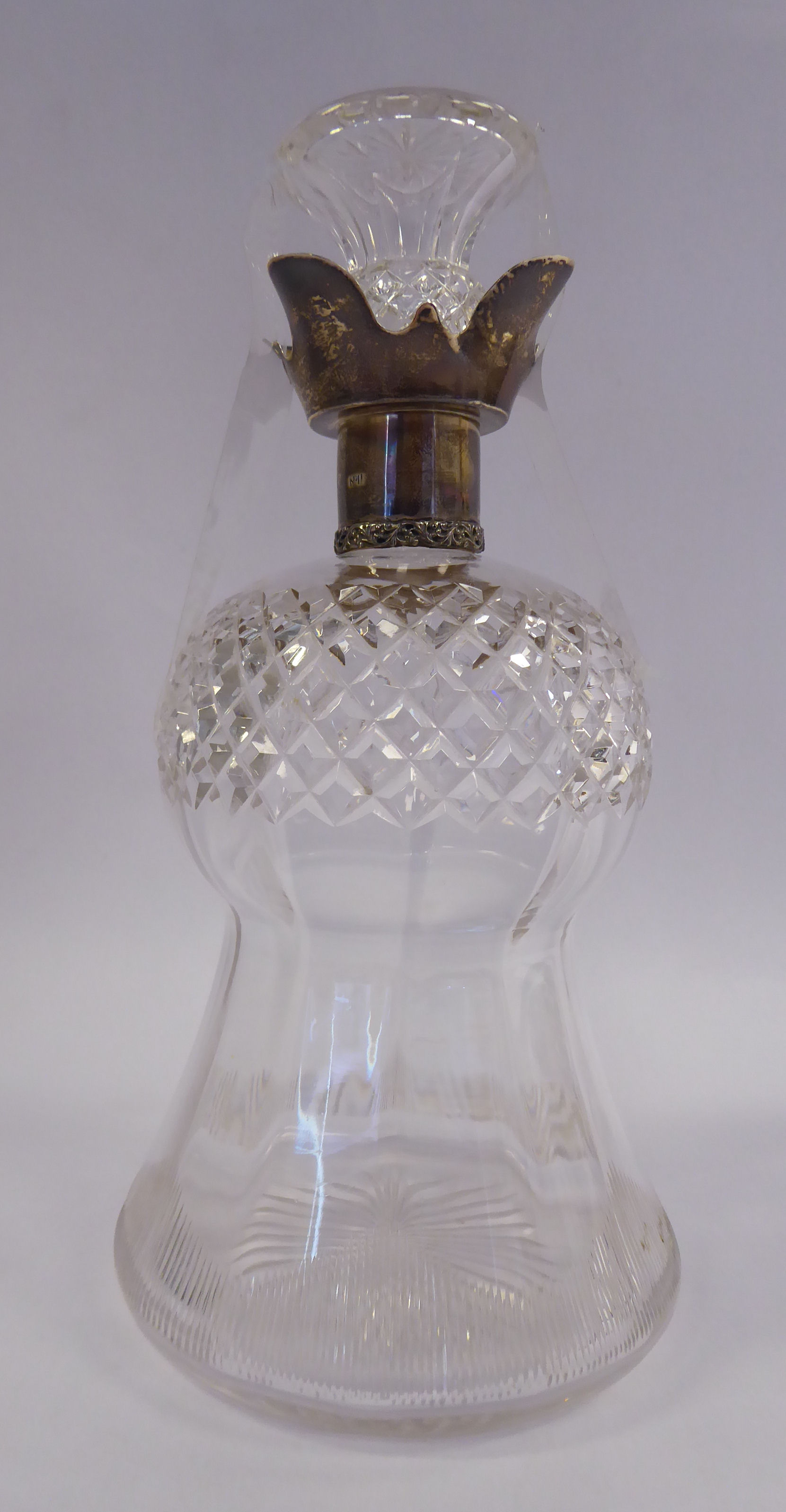 An Edwardian thistle design glass decanter with slice and diamond cut ornament and an applied,