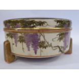 An early 20thC Satsuma earthenware covered box, elevated on block feet, decorated with gilding,