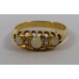 An 18ct gold claw set opal and diamond ring