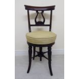 A William IV rosewood framed music stool with a scrolled,