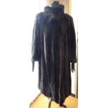 A black mink knee length fur coat with a collar,