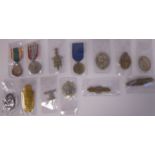 Thirteen military medals and lapel badges,