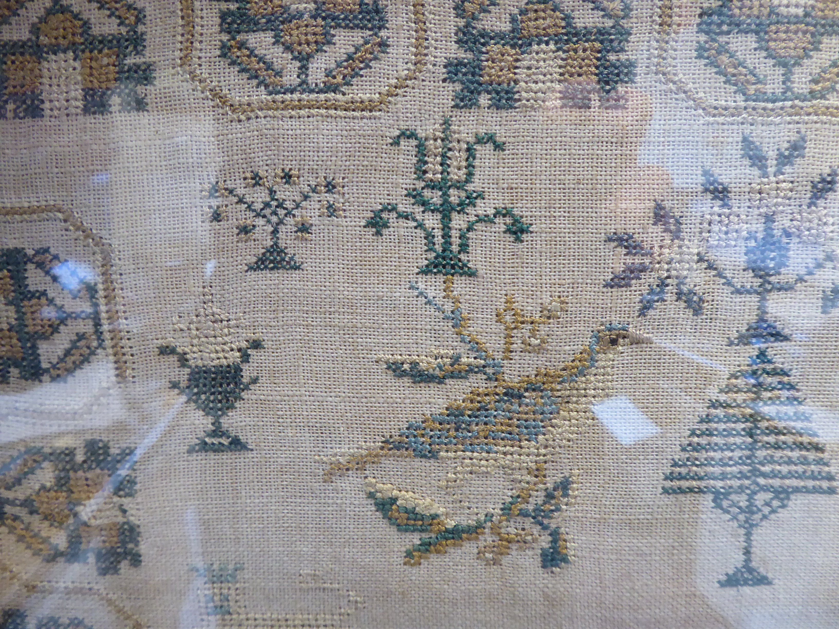 A George IV sampler, featuring a two storey house, stylised trees, birds and border ornament, - Image 4 of 4