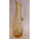 In the manner of Mary Gregory - a tinted amber coloured glass jug of tapered form with a drawn loop